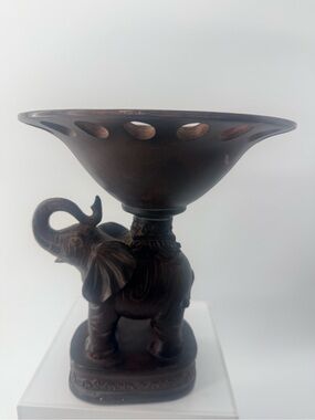 Decorative elephant pedestal centerpiece. Showcasing an elephant figurine.